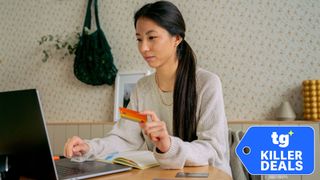 Young woman using a laptop and credit card for online shopping at home.
