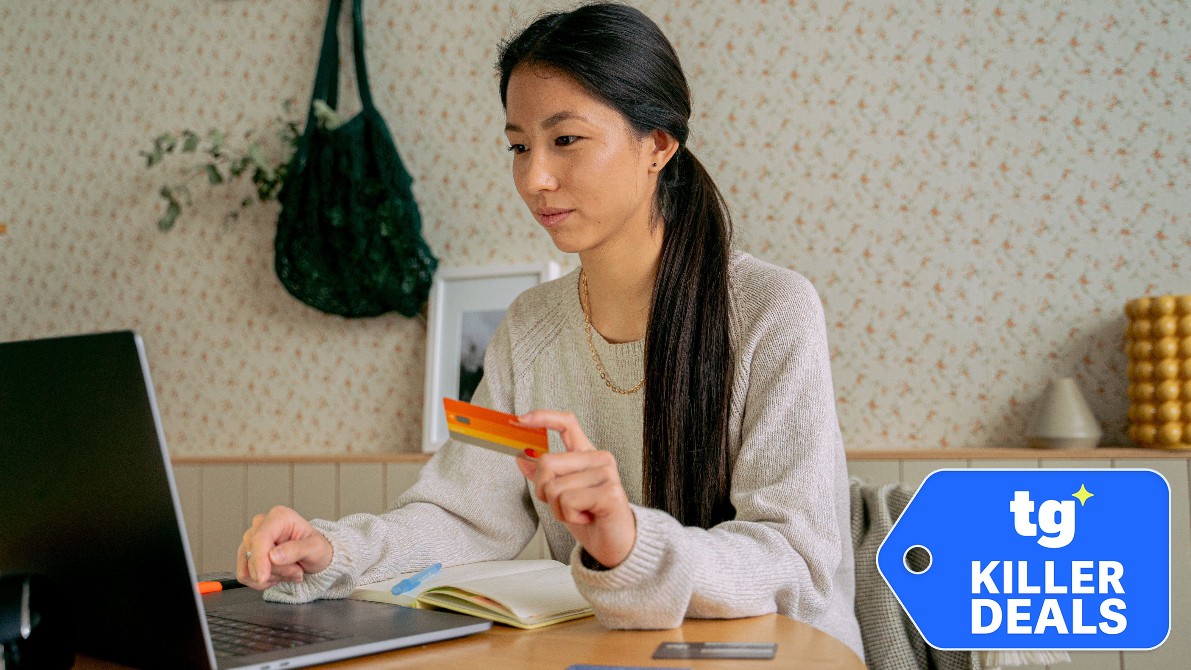 Young woman using a laptop and credit card for online shopping at home.