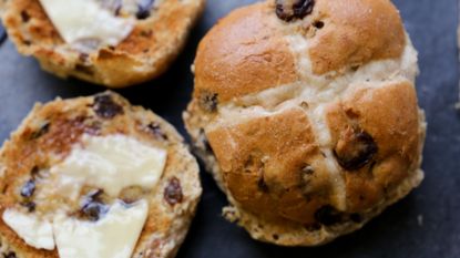 Hot cross buns spread with butter