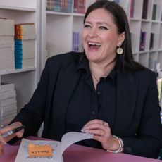 Author Callie Hart signs a book and smiles while attending the Los Angeles Times Festival of Books