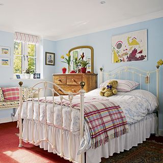 kids bedroom with yellow cushion and red carpet
