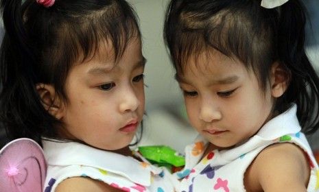 Angelica and Angelina play during a press conference in Palo Alto, Calif., before their successful separation surgery in November 2011. 