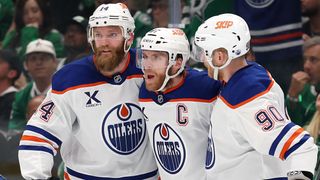 Connor McDavid #97 of the Edmonton Oilers celebrates with Mattias Ekholm #14 and Corey Perry #90 after scoring a goal against Casey DeSmith #1 of the Dallas Stars during the second period in Game Five of the Western Conference Final of the 2025 Stanley Cup Playoffs