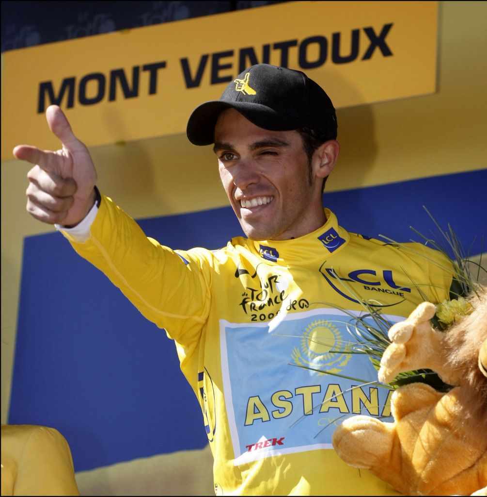 Alberto Contador doing his signature 'pistolero' victory salute on the podium in 2009