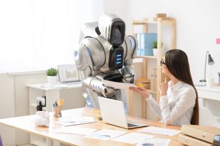 Representation of RPA showing an office worker and robot having a conversation by a desk