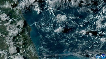 satellite aerial view of the Florida coast and a long white plume stretching along the atmosphere showing Artemis 2 launch.