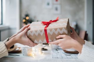 A gift box exchanging hands
