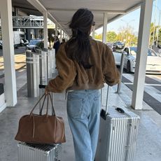 woman wearing chic airport outfit 2025