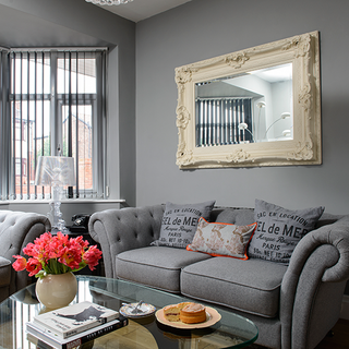grey living room with sofa an glass table