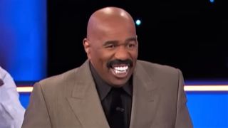 Steve Harvey smiling big on Family Feud