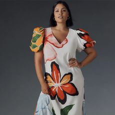 model wears floral dress with puff sleeves