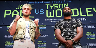 Jake Paul and Tyron Woodley stand for photos at the press conference for upcoming boxing match.