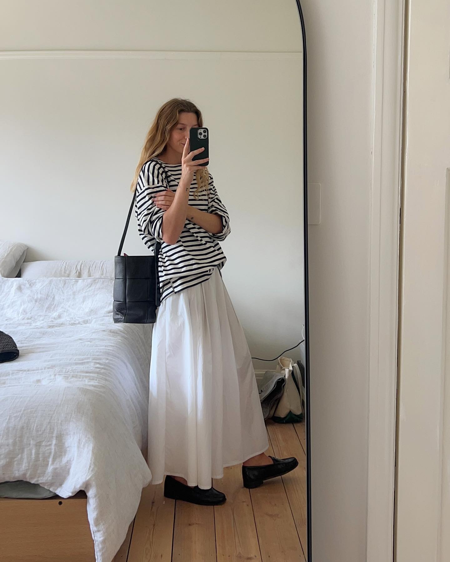 @brittanybathgate wearing a Breton stripe T-shirt with a white skirt and flats.