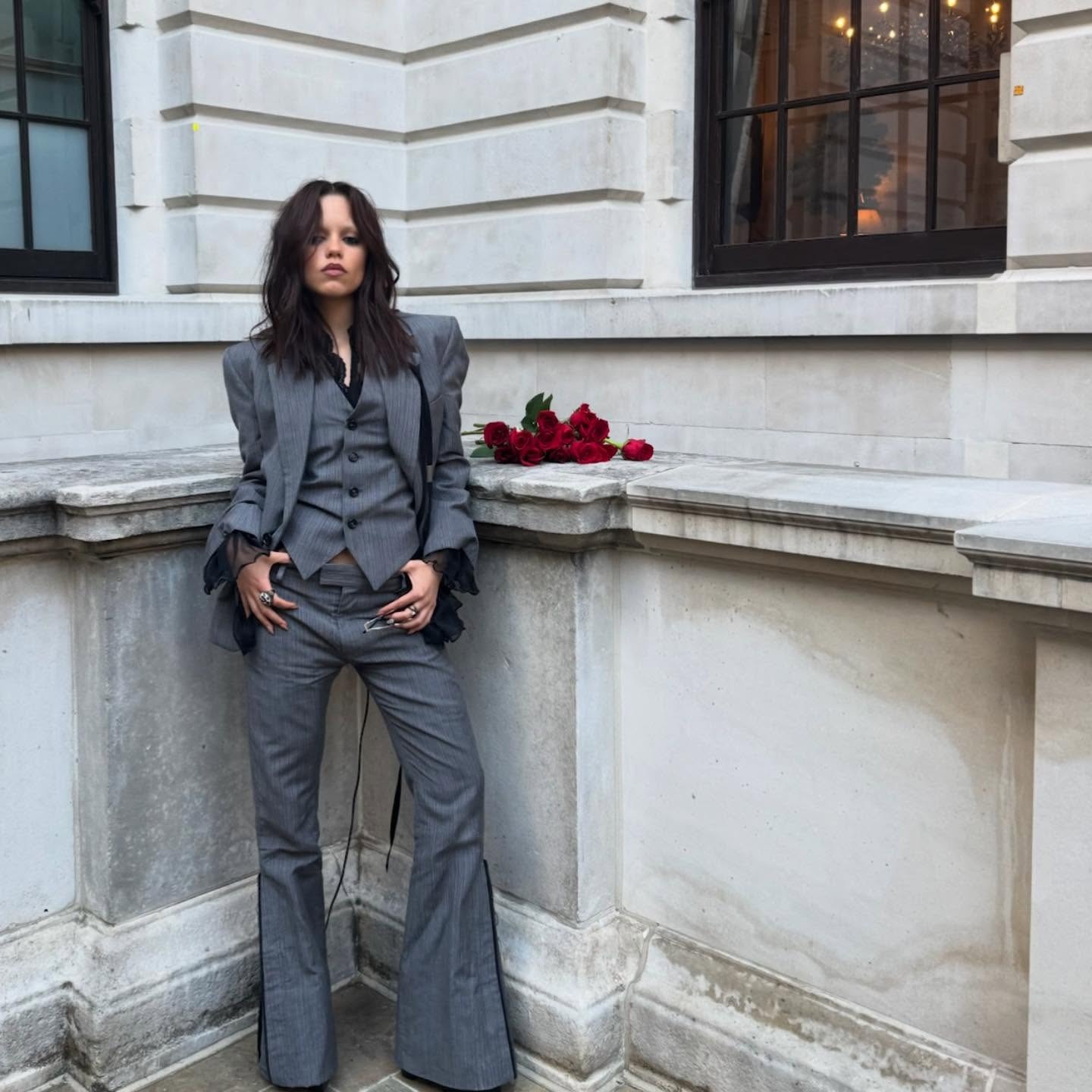 Jenna Ortega wearing a gray three-piece suit
