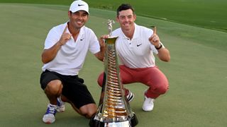 Rory McIlroy of Northern Ireland poses with the Harry Vardon Trophy with his caddie Harry Diamond after the final round on Day Four of the DP World Tour Championship