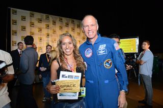 XCOR Chief Test Pilot/former NASA Astronaut Richard Searfoss (right) and Mercedes Becerra (left) of Paso Robles, Calif., winner of the trip to space given away at "The Big Bang Theory" panel at Comic-Con on July 13, 2012.