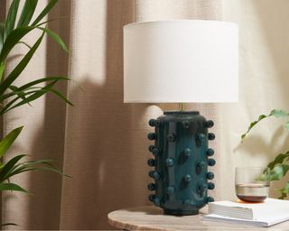 Bobble Table Lamp infront of beige curtains next to books and glass of water