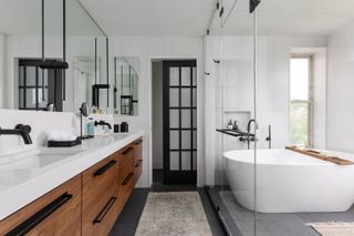 A modern bathroom with a double vanity and matt black plumbing fixtures