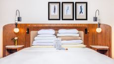 A white bed in a room at the Benjamin Royal Sonesta Hotel with different pillows from its pillow menu