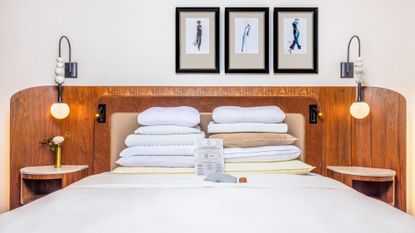 A white bed in a room at the Benjamin Royal Sonesta Hotel with different pillows from its pillow menu