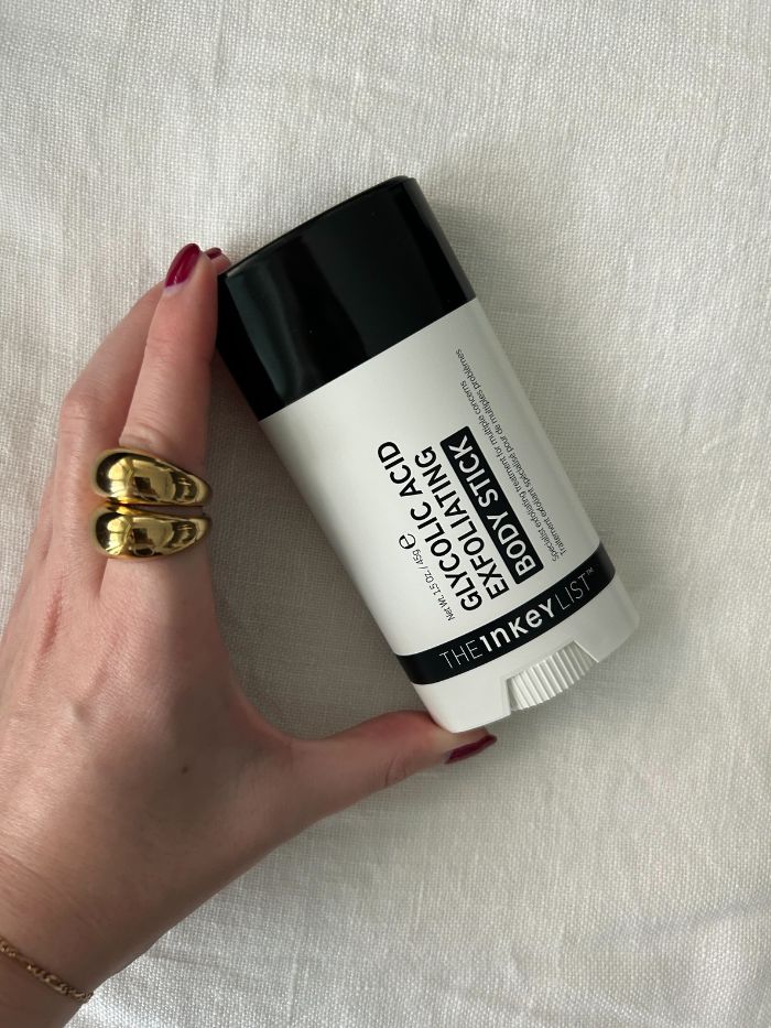Junior beauty editor Grace Lindsay holding The INKEY List Glycolic Acid Exfoliating Body Stick