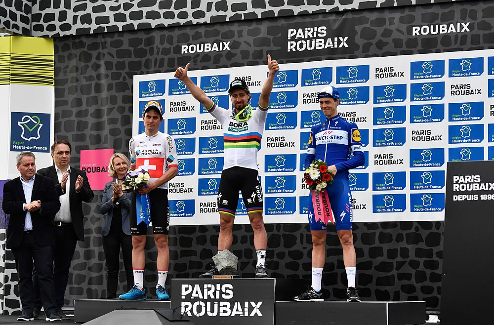 Peter Sagan on the podium at 2018 Paris-Roubaix, Silvan DIller second and Niki Terpstra third