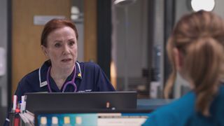 Siobhan in her navy work uniform talking crossly to Stevie Nash in Holby ED.