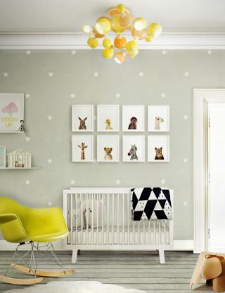 Nursery ideas featuring animal prints, gray star print wallpaper and a yellow rocking chair and pendant light.