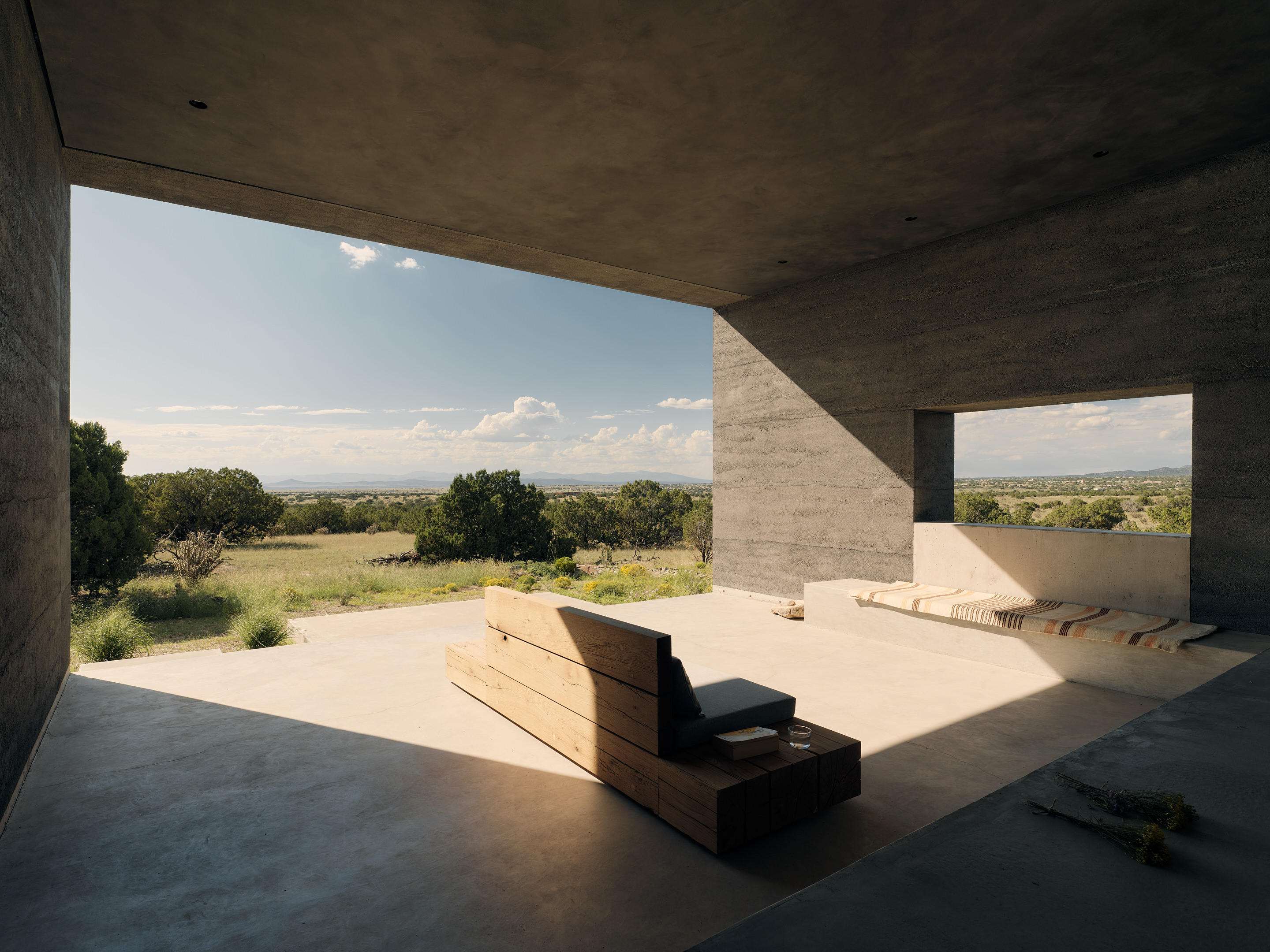 views of Sombra de Santa Fe, new mexico house, with dark, minimalist geometric volumes and clean walls and long nature views