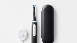 Oral-B iO Series 4 electric toothbrush in black with travel case and charging dock