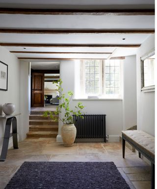 Hallway with beams and grey rug