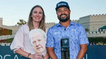 JJ Spaun and his wife Melody with the BMW PGA Championship trophy and a mask of Jeremy Clarkson