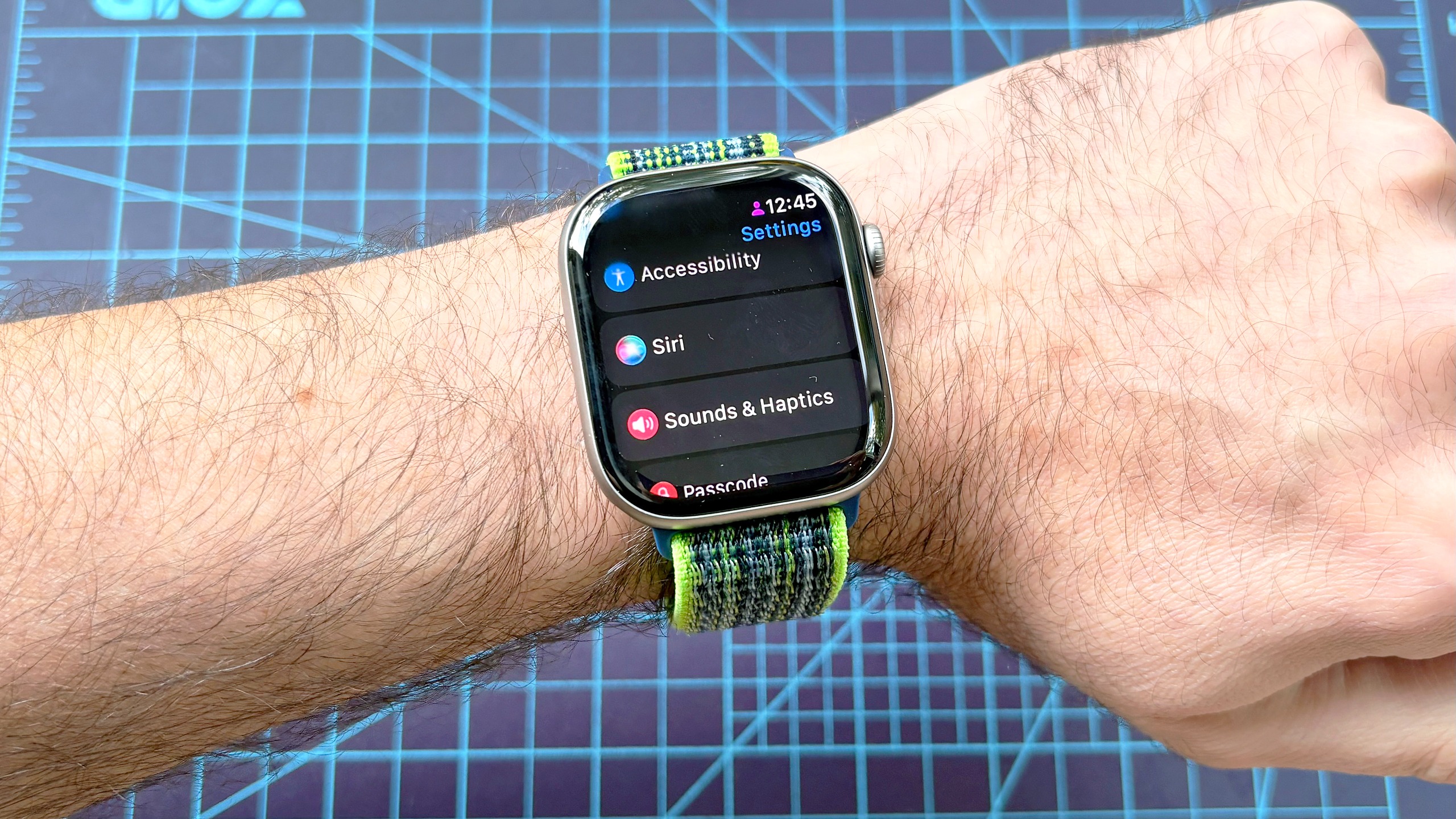 Close-up of the Siri AI setup process using an Apple Watch 11 and iPhone 16 Plus