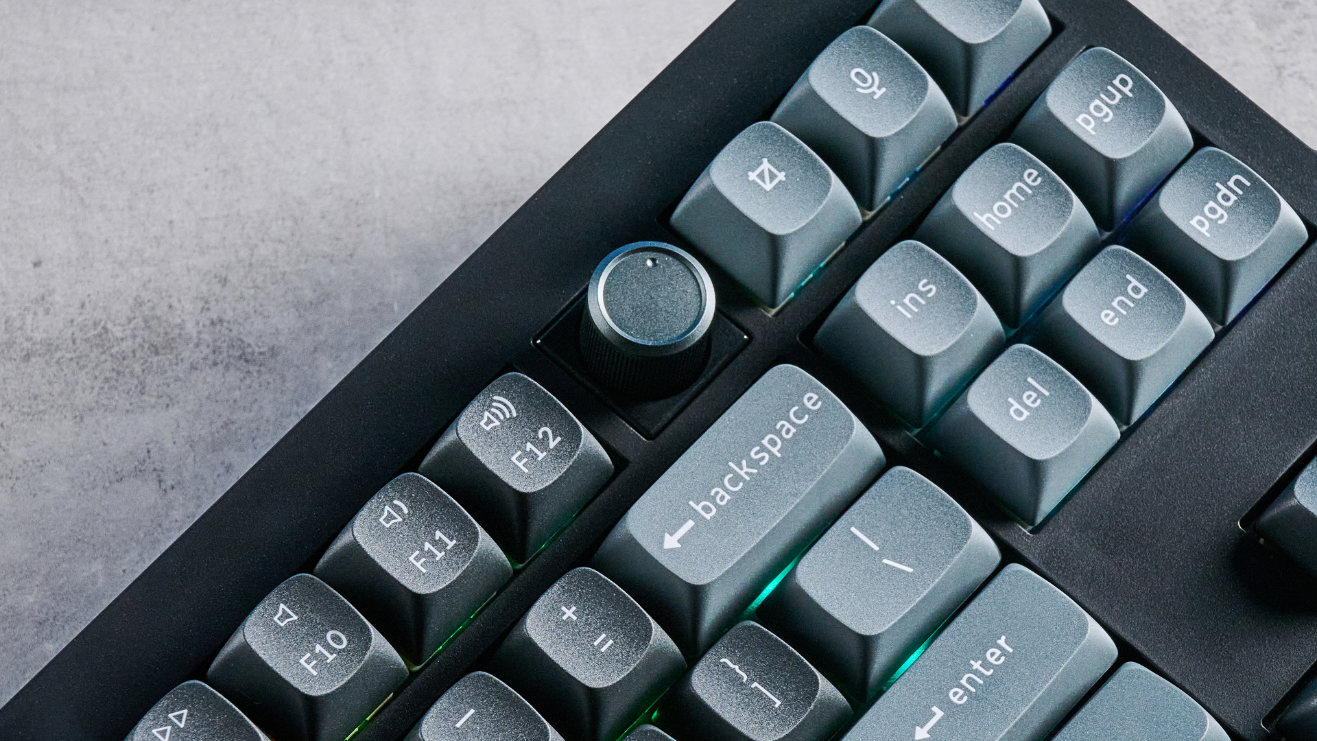 Keychron V3 Ultra 8K photographed on a grey table top in front of a blue background