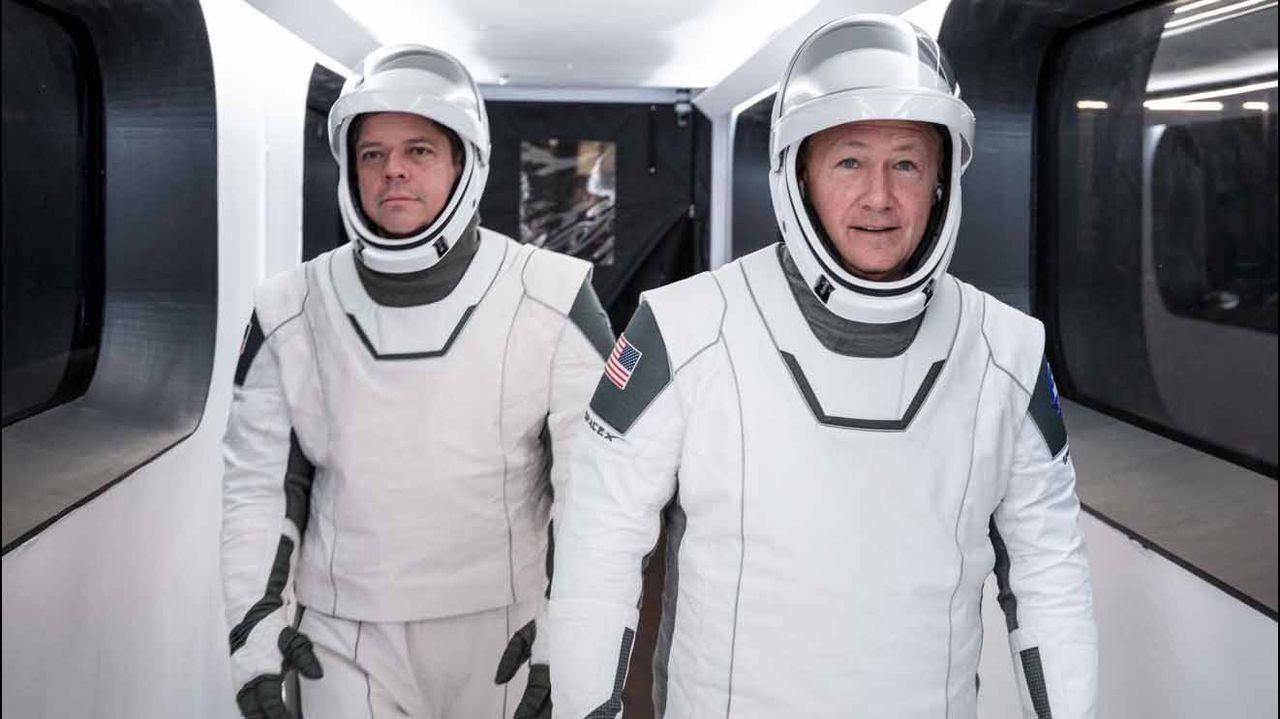 NASA astronauts Bob Behknen (left) and Doug Hurley will be the first to fly on SpaceX's Crew Dragon spacecraft during the Demo-2 mission. It could launch in Spring 2020. Here, they walk through the access arm in a dress rehearsal for launch during SpaceX in-flight abort preparations.