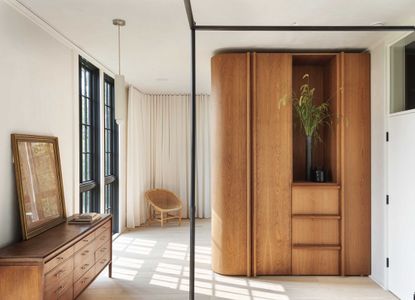 neutral bedroom with wood curved built-in wardrobe