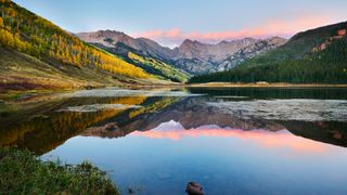Mountains reflected in Piney Lake in Vail Colorado at sunset