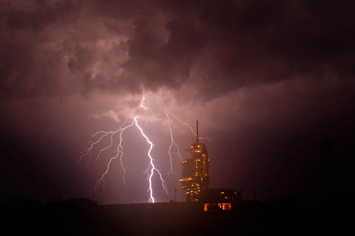 The space shuttle Endeavour is seen on launch pad 39a as a storm passes by prior to the rollback of the Rotating Service Structure (RSS), Thursday, April 28, 2011, at Kennedy Space Center in Cape Canaveral, Fla.