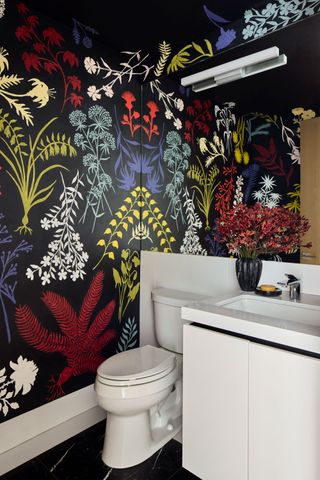 a powder room with a red blue and yellow wall mural