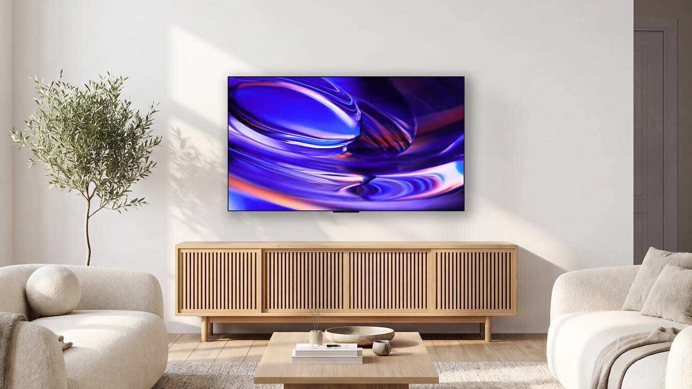 The Sony Bravia 6 OLED TV displaying abstract, colorful imagery from a wall-mounted position in a well-lit living room