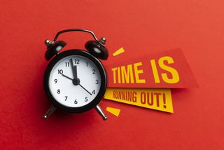 A black analog alarm clock against a red background with the text 'Time is running out!' displayed next to it.