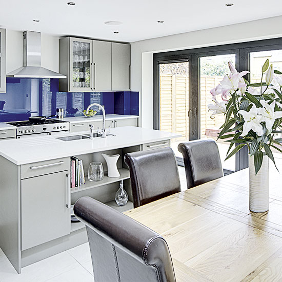 dining area with flower vase and black chairs