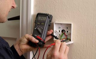 an electrician tests sockets, one of the biggest home renovation costs