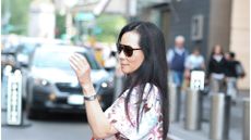lucy liu wearing a floral dress and sunglasses