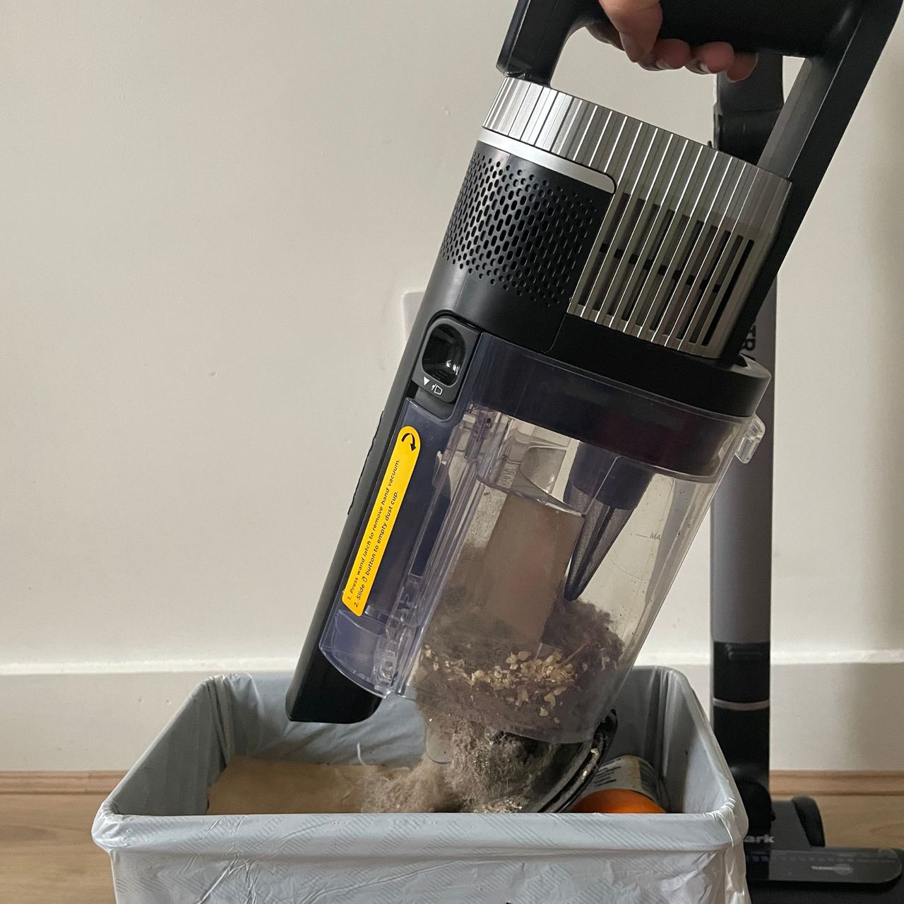 Emptying the Shark Stratos Cordless Vacuum into a bin