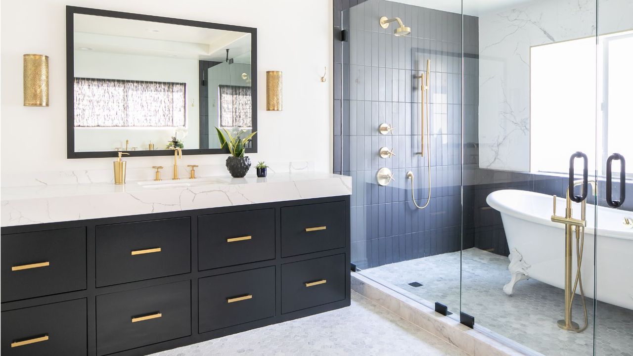 black and white tiled bathroom with vanity and roll top bath