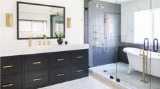 black and white tiled bathroom with vanity and roll top bath