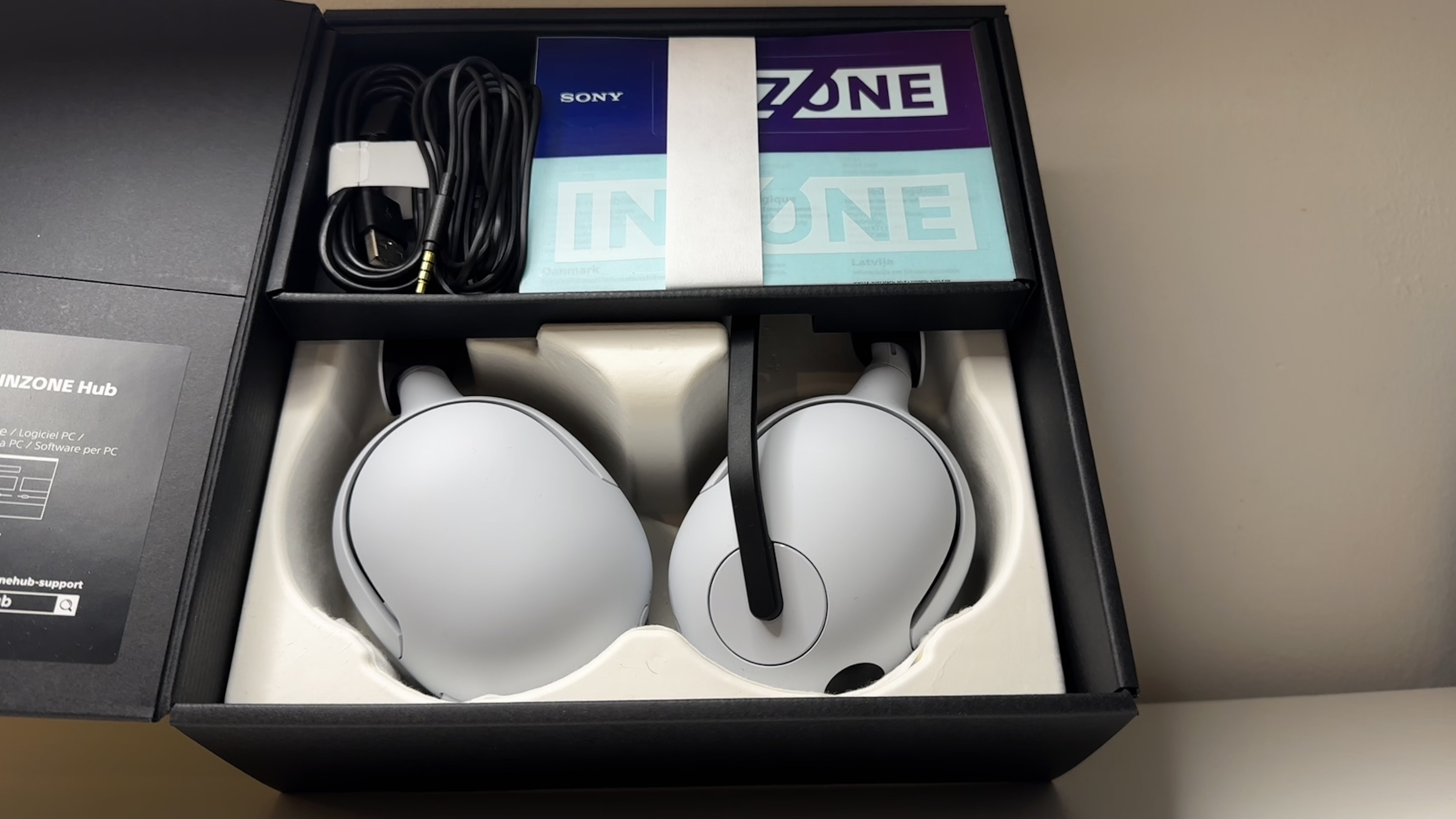 Sony InZone H5 gaming headset on a desk with packaging.