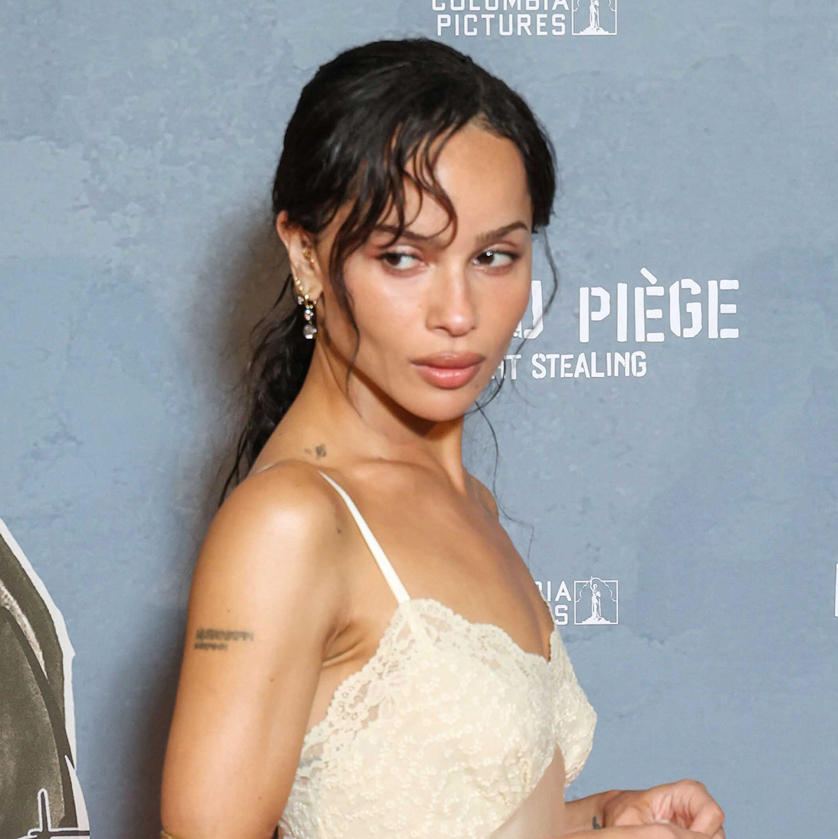 Zoe Kravitz wearing a Saint Laurent lace-trimmed slip dress on the Caught Stealing red carpet