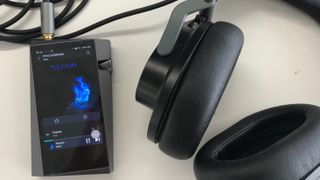 Astell & Kern A&norma SR25 MKII next to Austrian Audio headphones on a white background